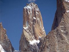 
The Trango Tower (6239 m), commonly called Nameless Tower, is a very large, pointed spire which juts 1000m out of the ridgeline. The Trango Monk (5850m) is to the left. The Trango Nameless Tower was first climbed in 1976 with Mo Anthoine, Martin Boysen reaching the summit on July 8, 1976 and Joe Brown and Malcolm Howells the next day.
